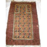 An old Eastern hand knotted wool prayer rug with geometric decoration on red and brown ground 49"