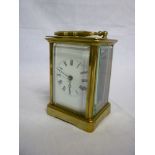 A French carriage clock with rectangular enamelled dial in brass traditional-style glazed case (af)