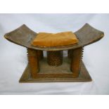 An African Ashanti carved wood stool with concave seat on rectangular base