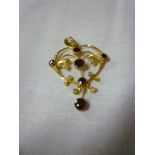 A 15ct gold Art Nouveau-style pendant set garnets and seed pearls