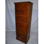 A late Victorian slim oak chest of six small drawers with turned handles