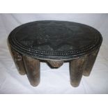 An old African multi-legged stool with carved circular top