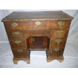 A late 18th/early 19th century inlaid figured walnut Queen Anne-style kneehole desk with a single