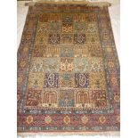A good quality old Eastern hand knotted wool rug with central rectangular panels of flowers and
