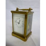 A good quality French striking carriage clock with rectangular enamelled dial in brass traditional