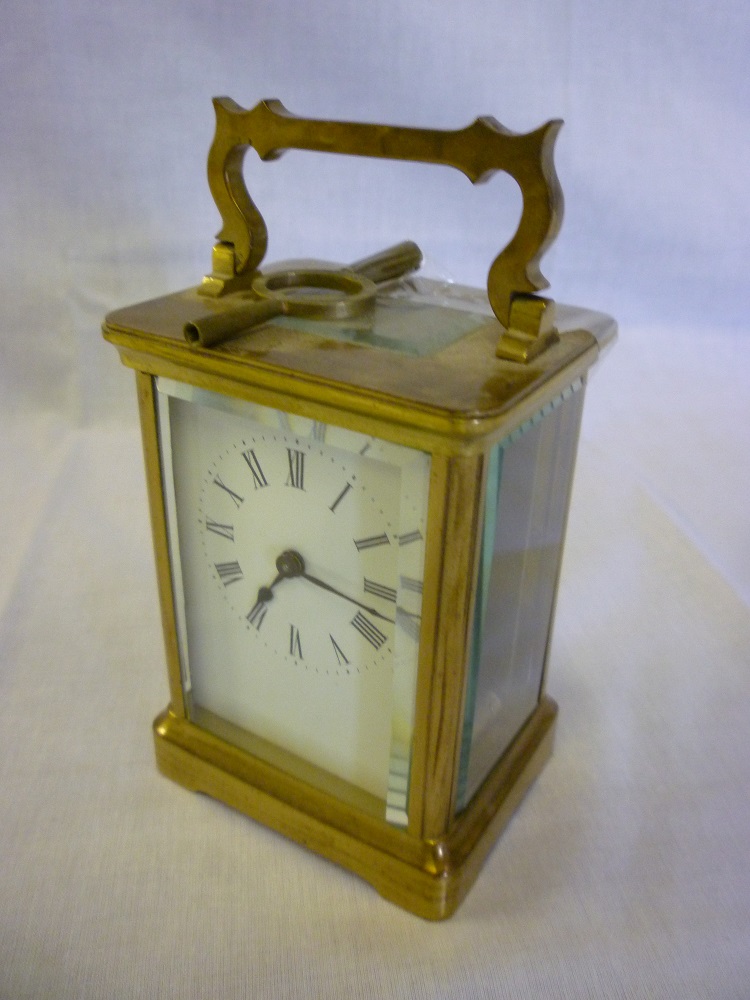 A good quality French carriage clock with rectangular enamelled dial in brass traditional-style case