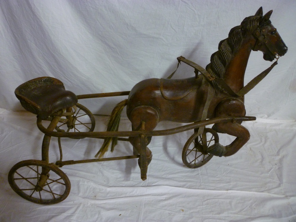 An  unusual Victorian-style carved wood horse tricycle, the trotting horse with articulate legs, 24"