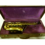 A brass saxophone by Hawkes & Son model "XXCentury" in fitted case with accessories