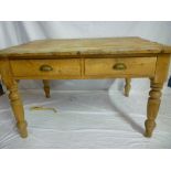 A Victorian polished pine rectangular kitchen table with two drawers in the frieze on turned tapered