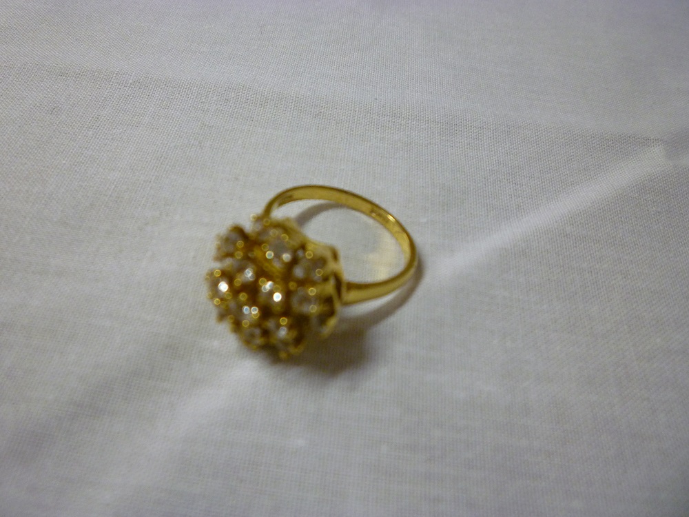 An 18ct gold dress ring set diamond cluster