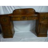 A 19th century Regency-style figured mahogany pedestal sideboard with three drawers in the frieze