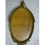 A good quality 19th century bevelled oval wall mirror in ornate gilt frame with urn finial and