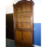 An early to mid 19th century mahogany bookcase with drawers and shelves enclosed by two panelled