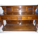 A Victorian carved walnut buffet with two drawers in the frieze above open recess with panel back