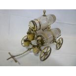An unusual silver plated four wheel brandy barrel cart with three cut glass brandy barrels with