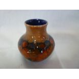 A Moorcroft pottery spill vase with pomegranate decoration, 3" high