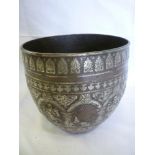 An old Middle Eastern silver overlaid bronze circular bowl decorated in relief with numerous Eastern