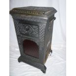An old cast iron square two handled stove "The Rippingille Patent" with red tinted glass front