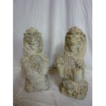 A pair of old weathered composition garden figures depicting seated lions holding the shields of