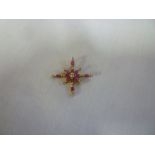 A 9ct gold star-shaped pendant set rubies and diamonds