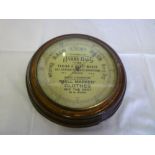 An unusual old advertising aneroid barometer, the circular dial marked "With Complements from