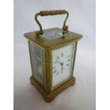 A French carriage clock with rectangular enamelled dial with striking and repeating movement in