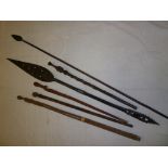 An old African Tribal spear, carved wood paddle and four various African carved wood walking