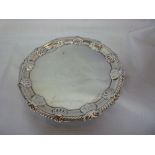 A George II silver shaped circular waiter tray with engraved decoration and decorated borders,