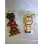 Two painted metal money boxes, one in the form of a Coca Cola salesman, the other of a seated figure