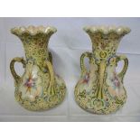 A pair of Japanese china three handled vases with painted floral panels and raised encrusted