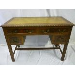 An Edwardian mahogany rectangular writing table with inset leather writing surface, two frieze