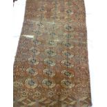 An old Eastern hand knotted wool rug with medallion decoration on red ground (af) 67" x 40"