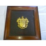 An unusual lacquered wood rectangular coach panel with raised gilt armorial crest "Arms of Sir