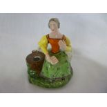 A mid 19th century Staffordshire pottery ink well in the form of a seated female by a tree stump