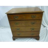 A small 19th century mahogany chest of four long drawers with brass ring handles on bracket feet