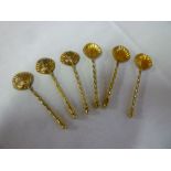 A set of six Victorian silver gilt condiment spoons with scalloped-shaped bowls and twisted stems,