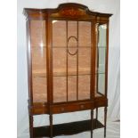 A late Victorian/Edwardian inlaid mahogany display cabinet with glass shelves enclosed by a