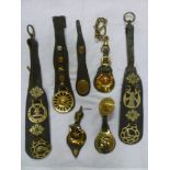 Seven leather straps containing a selection of mainly original horse brasses including makers oval