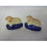 A pair of Staffordshire pottery pen holders in the form of recumbent sheep with encrusted