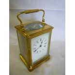 A good quality large carriage clock with enamelled rectangular dial in brass glazed traditional-