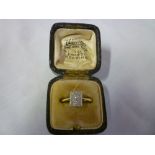 An 18ct gold dress ring with platinum mounts set a rectangular panel of twelve diamonds