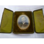 A good quality miniature gilt oval frame with folding stand in velvet lined case