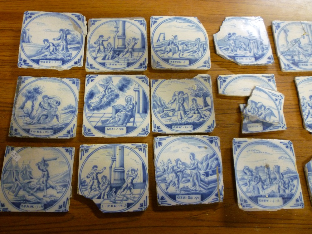 Twelve 18th century blue and white ceramic tiles depicting biblical scenes and figures together with
