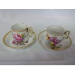 A pair of 19th century German porcelain cylindrical coffee cups and saucer with painted floral