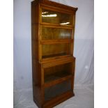 A good quality Globe Wernicke-style oak five tier stacking sectional bookcase with folding glazed