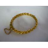 A 9ct gold bangle with rope twist decoration
