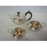An Edward VII silver squat-shaped three piece teaset comprising circular teapot with hinged lid