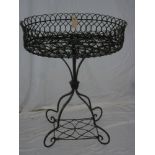 A 19th century wirework oval plant stand with pierced borders on tapered stand with rectangular base