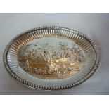 A George III oval pin tray, the centre decorated in relief with a country scene with cottage and