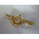 A ladies old 9ct gold wristwatch by Rolex with circular enamelled dial and 9ct gold strap